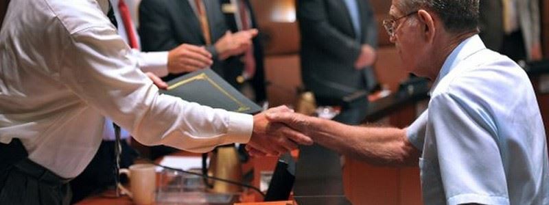 Man Receiving Letter of Recognition