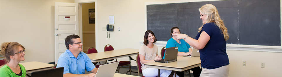 business meeting participants working at tables in a classroom at The Clayton Center 